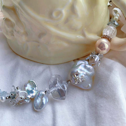 Freshwater baroque pearl bracelet featuring a central iridescent pearl decorated with a small sparkling butterfly accent.